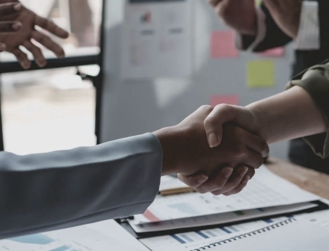 Business professionals shaking hands in partnership